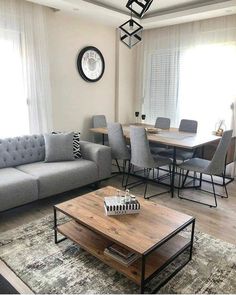 a living room filled with furniture and a wooden table