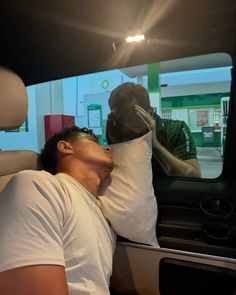 a man sleeping in the back seat of a car