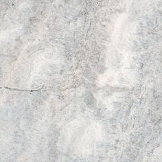 a white marble textured surface with grey streaks