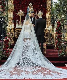 the bride and groom are getting married in front of an elaborate altar decorated with red flowers