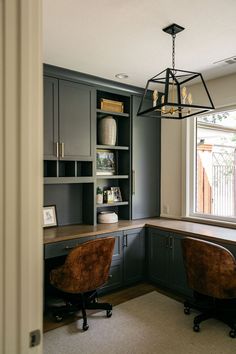 a home office with built in cabinets and chairs