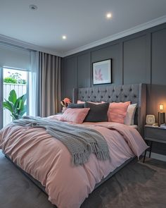 a bedroom with a bed, nightstands and large windows in it's center