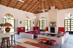 a living room filled with furniture and lots of windows