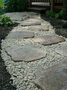 a garden path made out of rocks and gravel