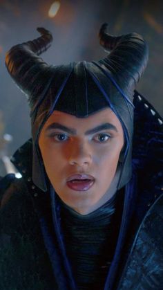 a man with horns on his head wearing a black outfit