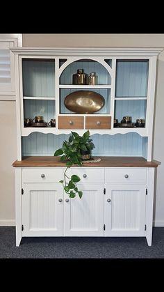 a white hutch with some plants in it