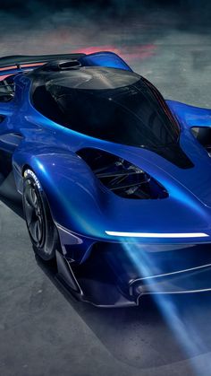 a blue sports car with its hood open