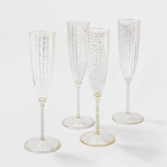 four champagne flutes sitting next to each other