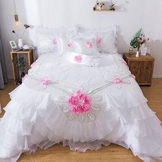 a white bed with pink flowers on it