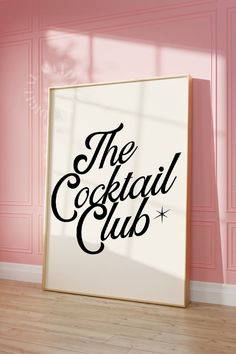 the cocktail club sign is displayed in front of a pink wall and hardwood flooring