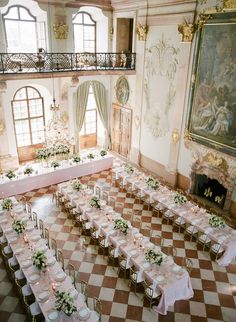 a large room with tables and chairs set up for a formal function in the center