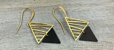 "This pair of modern geometric earrings are made of two abstract triangles in contrasting colors and opposite directions. The delicate gold triangles are hammered by hand with care. Along with the 22K gold plated earring hooks, it is lightweight and comfortable -- a perfect gift for every day or an evening out! Item Details * Total length of earrings: 1 3/4\" including earring hooks * Earring hooks: 22K gold plated * Big triangles: Hand hammered. 3/4\" high and 3/4\" wide * Small Triangles: Oxid Modern Geometric Earrings For Party, Modern Triangle Earrings For Party, Modern Triangle Party Earrings, Modern Geometric Party Earrings, Modern Handmade Triangle Jewelry, Modern Single Triangle Earring, Modern Black Triangle Jewelry, Modern Triangle Metal Earrings, Gold Triangle Metal Earrings