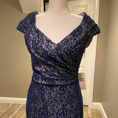 a dress on display in a room with a mannequin head and neckline