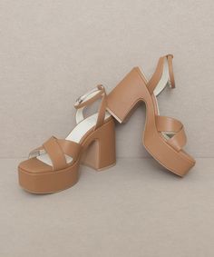 This gorgeous chunky sandal is bringing all the 70's glam. The Norah features a cross strap front and a sweet ankle buckle detail.Heel Height: 4.25"The front platform: 1.5"Types of closures: Slip on/ BuckleClog, Retro, Vintage Chic Ankle Strap Block Heels With Platform, Brown Chunky Platform Sandals For Party, Chic Platform Sandals With Cross Strap, Chic Cross Strap Platform Sandals, Party Wedge Sandals With Block Heel In Medium Width, Party Wedge Sandals With Block Heel Medium Width, Party Wedge Sandals With Block Heel And Medium Width, Brown Ankle Strap Block Heels For Party, Spring Platform Heels With Cross Strap