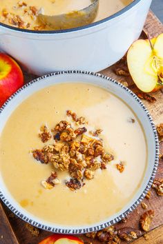 two bowls filled with oatmeal next to an apple