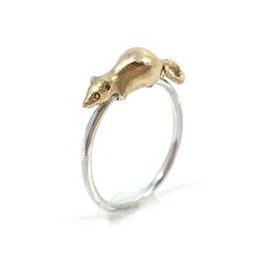 This meticulously hand-carved rat is cast in 14 karat yellow gold and sits on a sterling silver band which it can ride all the way around! It is a wonderful distraction which sits on your finger, awaiting your guidance to move the rat around the band at any time. Based on a Victorian design of a mouse ring made by Thornhill & Co. circa 1880, this is my take on a RAT ring! Your order will contain one 14k gold and sterling silver ring as seen in the photos. Due to the bespoke nature of the process, slight variations will naturally occur. This ring is made by special order and will take 4-6 weeks to create.  If you want it in a size that is not listed, please contact me before ordering. Spinning Rat, Rat Ring, Mouse Ring, A Rat, Victorian Design, Sterling Silver Bands, Silver Band, Rats, Rings Statement