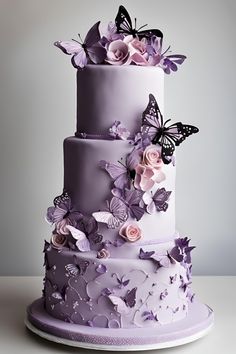 a three tiered cake with purple flowers and butterflies on it