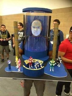 a man standing in front of a giant display with toys on it's sides