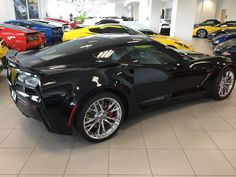 a black sports car is parked in a showroom