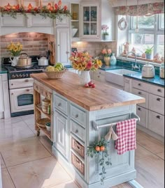 a kitchen with an island in the middle of it and lots of cabinets on both sides