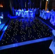 the dance floor is lit up with blue lights