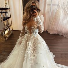 a woman is taking a selfie in her wedding dress while looking into the mirror