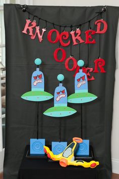 a black table topped with toys next to a sign that says kwoked oork