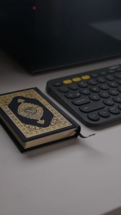 a book sitting on top of a desk next to a keyboard