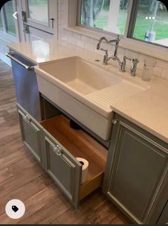 a kitchen sink with drawers underneath it