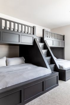 two beds with storage underneath them in a room that has carpeted flooring and white walls