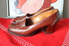 70s leather shoes made and designed in Finland Comfort pump with classic design features such as scalloped edging and pinholes All made by hand including the inside of the shoe Quality workmanship throughout Very Mod in style and would go well with a 60s dress! Label: Design Marja-Leena Size 8 to 8 1/2 in US sizing Measures 9 3/4 inches (approx) from back of heel to toe on the inside of the shoe Heel height is 2 1/4 inches Excellent vintage condition If you love these shoes and love Finnish desi Vintage Leather Cap Toe Heels, Vintage Leather Shoes With Pointed Toe For Fall, Vintage Wingtip Leather Shoes For Fall, Vintage Leather Heels With Brogue Detailing, Vintage Pointed Toe Heels With Brogue Detailing, Retro Leather Heels With Brogue Detailing, Vintage Heels With Brogue Detailing And Almond Toe, Vintage Almond Toe Heels With Brogue Detailing, Vintage Wingtip Heels With Brogue Detailing