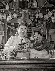 black and white photograph of two men at a bar