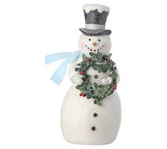 a white snowman with a wreath on his chest and a blue bow around his neck