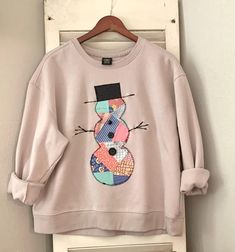 a pink sweatshirt with a snowman on it