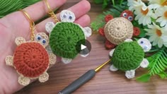 crochet keychain with three little turtles on it and a flower in the background