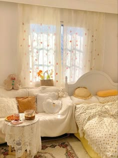 a white couch sitting in a living room next to a table with food on it