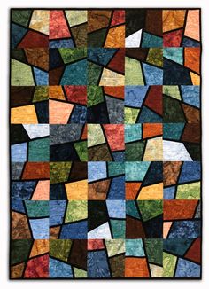 a multicolored patchwork quilt with squares and rectangles in different colors