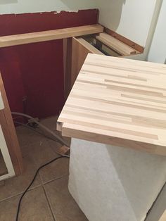 an unfinished kitchen counter is being built