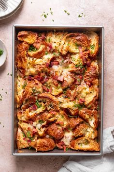 a casserole dish with meat, cheese and vegetables in it on a table