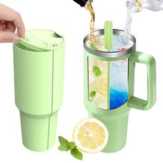 a person is pouring water into a cup with lemon slices and mint