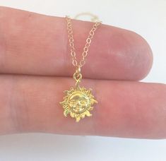 A beautiful, tiny gold sun necklace.  Perfect for summer!This shiny gold vermeil sunburst charm is strung from a delicate, high quality 14k rose gold filled chain.Wear it alone as an everyday necklace or layer it with other pieces for that chic layered look.__________________________________D E T A I L S:Sun Pendant- Gold Vermeil- Approximately 1/3" long- Shiny & Dainty__________________________________O U R - S H O P - I N F O:- Each piece is carefully hand-crafted in our NC, USA studio!- W Gold Dainty Sun-shaped Jewelry, Dainty Gold Sun-shaped Jewelry, Dainty Sun-shaped Gold Jewelry, Gold Dainty Sun Design Charm Necklace, Dainty Gold Charm Necklace With Sun Design, Gold Sun Necklace, Starburst Pendant, Sun Charm, Sun Necklace