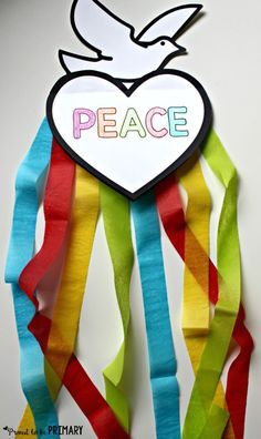 a piece of paper with the words peace on it and a heart hanging from it