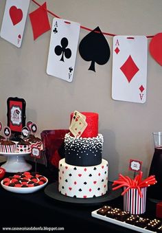 a casino themed birthday party with cards on the wall and cake, cupcakes and cookies