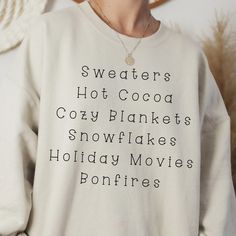 Wrap Yourself In The Comfort Of Winter's Joys With Our 'Winter Favorites List Sweatshirt'. Featuring A Chic List Of The Season's Bestfrom Sweaters To Bonfiresit's The Perfect Piece To Cozy Up In While Sipping Cocoa Or Watching Holiday Movies. Available In Various Colors And Sizes Exclusively On Our Website. Crafted With Love And Care By Our Dedicated Small Business, Offering You A Unique Blend Of Style And Warmth This Holiday Season. White Relaxed Fit Sweatshirt For Winter, Winter White Letter Print Sweatshirt, White Letter Print Sweatshirt For Winter, Cozy White Sweatshirt With Graphic Print, White Letter Print Cozy Top, Cozy White Tops With Letter Print, White Letter Print Tops For Winter, White Letter Print Cozy Fit Top, Cozy White Top With Graphic Print