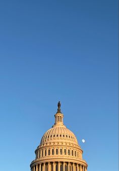 the u s capitol building in washington, d c is seen against a blue sky