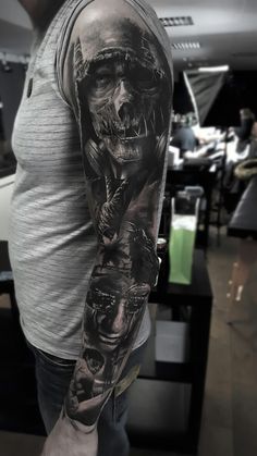 a man's arm with a black and white tattoo design on the left sleeve