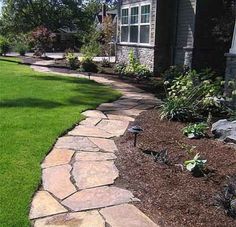 a stone walkway in front of a house