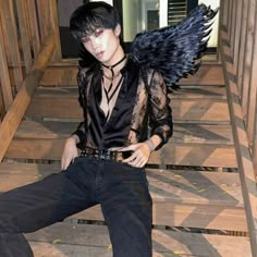 a man with wings sitting on some steps