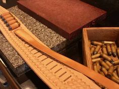 two wooden boxes filled with lots of different types of cigars next to each other