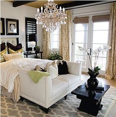 a chandelier hanging from the ceiling in a bedroom